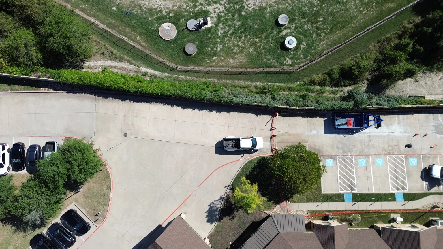 Aerial view of commercial pavement, parking and a cordoned work area
