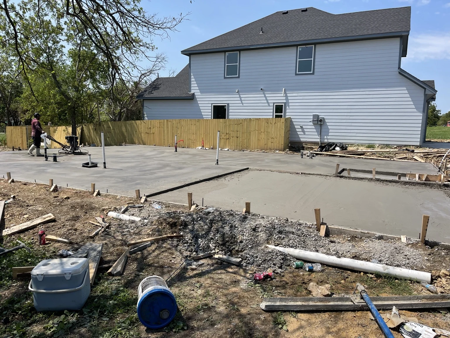 Concrete placement alongside an existing home